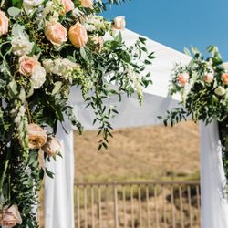 A stunning altar design framing unforgettable promises. Elevating desert views with lush, luxurious floral design.