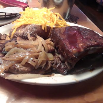 Texas Roadhouse - steak smothered in onions and mushrooms with a side of ribs and a baked potato - Steakhouses Near Me - Macon, Georgia