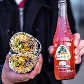 Loz Takos - a man holding a burrito and a bottle of jalapeno - Mexican Near Me - Abbotsford, British Columbia Loz Takos - a man holding a burrito and a bottle of jalapeno - Mexican Near Me - Abbotsford, British Columbia