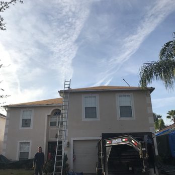 Five Star Roofing and Construction - two men standing on a ladder in front of a house - General Contractors Near Me - Tampa, Florida