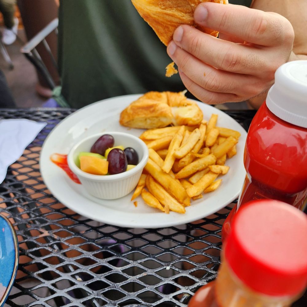 Wildflower Cafe - a person eating a sandwich and french fries - Breakfast & Brunch Near Me - Redondo Beach, California Wildflower Cafe - a person eating a sandwich and french fries - Breakfast & Brunch Near Me - Redondo Beach, California