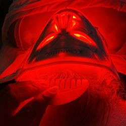 Gua Sha scalp massage paired with Red light therapy mask during an anti-aging facial treatment.