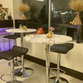 Dessert Elegance - a marble table with four stools - Desserts Near Me