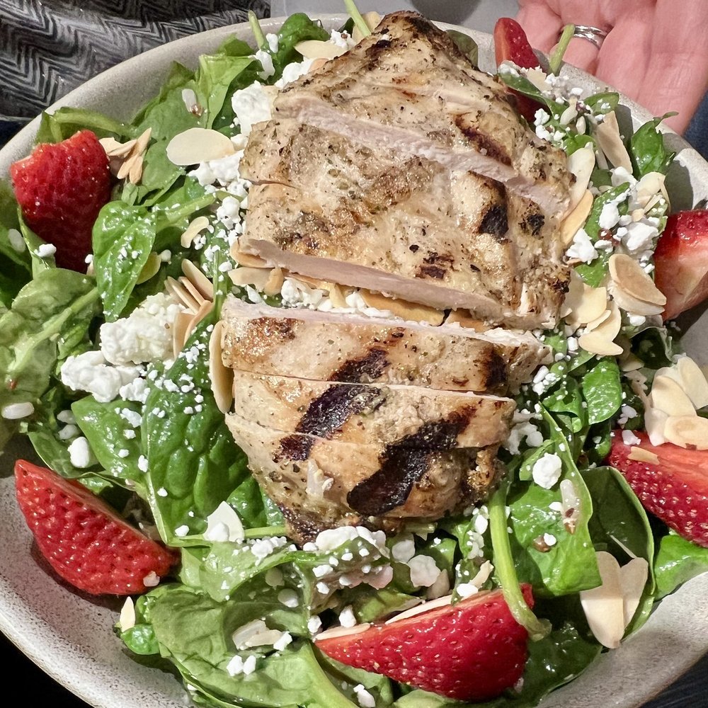 Tysons Rickhouse - a person holding a plate of food - Salad Near Me - Tysons, Virginia
