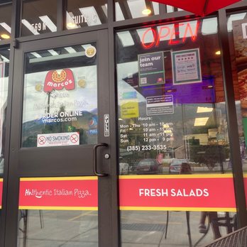Marco's Pizza - The front doors explaining everything as well as place to sit outside if you are uncomfortable standing inside - Pizza Near Me - Lindon, Utah