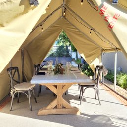 a table and chairs in a tent