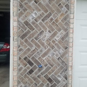 GG Brick Construction - a brick wall with a blue sticker on it - General Contractors Near Me GG Brick Construction - a brick wall with a blue sticker on it - General Contractors Near Me