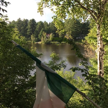 Sim's Irish Pub - a view of a river and a flag - Irish Pub Near Me - Rawdon, Quebec