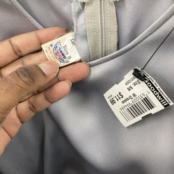 Goodwill Store & Donation Center - Garment workers tag on a vintage dress