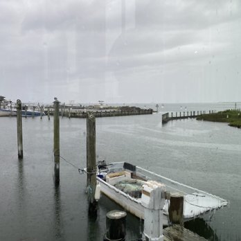 Hatteras Sol Waterside Grill - View of the sound from inside the restaurant on a rainy day - New American Near Me - Hatteras, North Carolina Hatteras Sol Waterside Grill - View of the sound from inside the restaurant on a rainy day - New American Near Me - Hatteras, North Carolina
