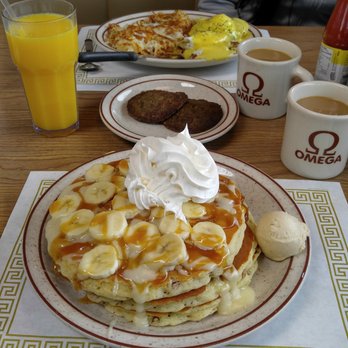 Omega Pancake House - Eggs Benedict with hash browns and sausage patties. Pancakes with walnuts, bananas, and icing with very tasty OJ! - Breakfast & Brunch Near Me - Surfside Beach, South Carolina