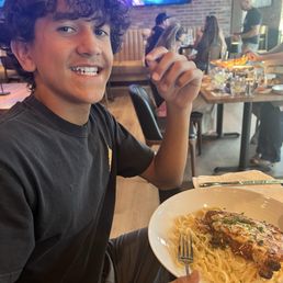 Chicken Parmesan with fettuccine noodles and one happy teen! Chicken Parmesan with fettuccine noodles and one happy teen!