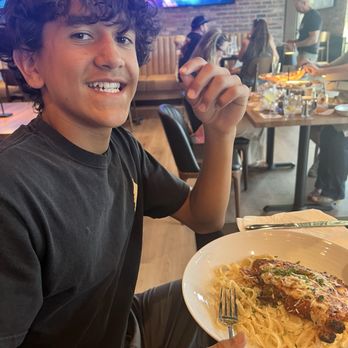 Amici Pizzeria & Bar - Chicken Parmesan with fettuccine noodles and one happy teen! - Pizza Near Me - Reno, Nevada Amici Pizzeria & Bar - Chicken Parmesan with fettuccine noodles and one happy teen! - Pizza Near Me - Reno, Nevada