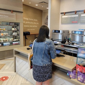 Proper Food - a woman standing at a counter - Salad Near Me - New York, New York Proper Food - a woman standing at a counter - Salad Near Me - New York, New York