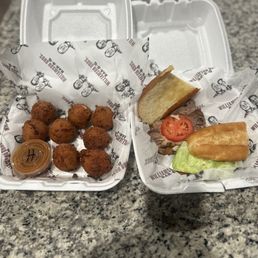 Brisket Hoagie Sandwich & Hush Puppies with Honey BBQ Sauce. Brisket Hoagie Sandwich & Hush Puppies with Honey BBQ Sauce.