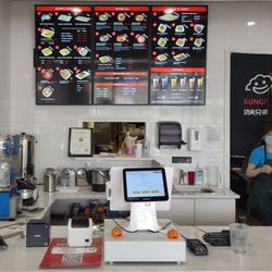 KungFu Bros Dumplings & Noodles - Menu screens behind the service counter