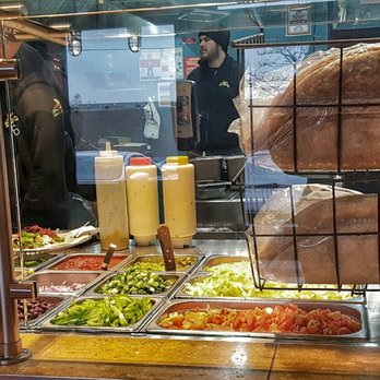 Burrito Boyz - a burrito being served at a buffet - Mexican Near Me - Toronto, Ontario Burrito Boyz - a burrito being served at a buffet - Mexican Near Me - Toronto, Ontario