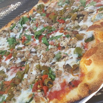 Back Road Pizza - The Byron with added green chile.  So good! The crust is thin and the slices are cut wide so you can fold it. - Pizza Near Me - Santa Fe, New Mexico