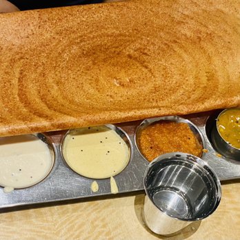 Saravanaa Bhavan - a pancake with sauces and condiments - Indian Near Me - New York, New York Saravanaa Bhavan - a pancake with sauces and condiments - Indian Near Me - New York, New York