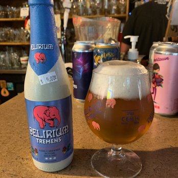 Sergio's World Beers - a glass of beer next to a bottle of beer - Dive Bars Near Me - Louisville, Kentucky