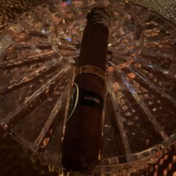 a cigar on a glass table a cigar on a glass table