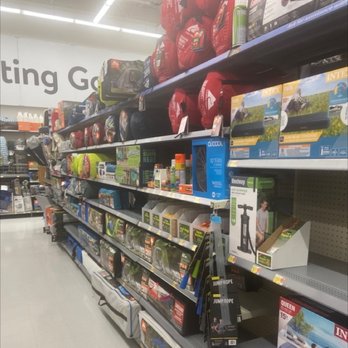 Walmart - Store shelves hold outdoor gear, including jump ropes, air pumps, and camping accessories, in a retail environment. - Department Stores Near Me - Burke, Virginia
