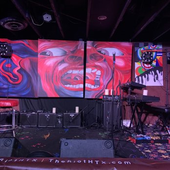 The Riot Comedy Club - a stage with a painting of a clown - Comedy Clubs Near Me - Houston, Texas The Riot Comedy Club - a stage with a painting of a clown - Comedy Clubs Near Me - Houston, Texas