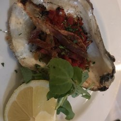 The Whitstable Oyster Company - Grilled rock oyster 'Casino' with bacon and peppers.