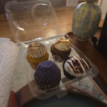 Buttercup Bake Shop - Ube Cupcake (Bottom Left), Lemon raspberry meringue cupcake (top left), devil dog cupcake (Bottom Right), Hummingbird Cupcake (Top Right) - Bakeries Near Me - New York, New York