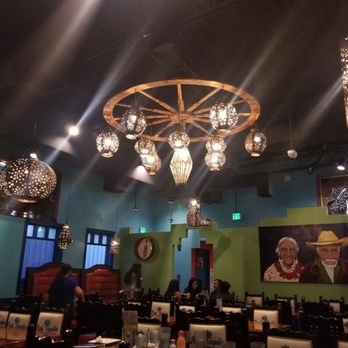 Azul Tequila - Interior of a Mexican-themed restaurant with hanging lanterns and a wagon wheel chandelier, featuring tables, chairs, and wall art. - Mexican Near Me - Sebring, Florida