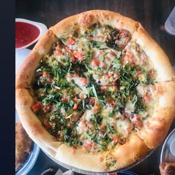 Satchel's Pizza - PESTO SAUCE instead of regular tomatoe!!!! On this pizza. Mozarelle, basil, tomatoe, and bacon. It was so good!!! - Pizza Near Me - Gainesville, Florida