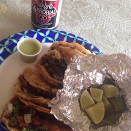Two carne asada tacos and two tacos al pastor. Topped taco truck-authentic with onions and cilantro. Legit