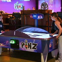 Pinz - Friendly competition, settled on the air hockey table.