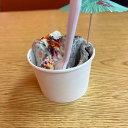 a cup of ice cream with sprinkles and an umbrella a cup of ice cream with sprinkles and an umbrella
