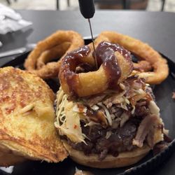 Off The Hook Tavern - Cowboy Burger. Burger, pulled pork, bacon, coleslaw, onion ring, bbq sauce, cheddar cheese