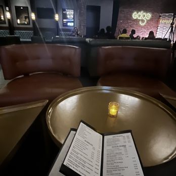 Edge - a table with a menu and a candle on it - Bars Near Me - Baton Rouge, Louisiana