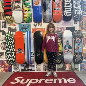 Supreme - My daughter and I in front of their skateboard wall art - Men's Clothing Near Me - San Francisco, California Supreme - My daughter and I in front of their skateboard wall art - Men's Clothing Near Me - San Francisco, California