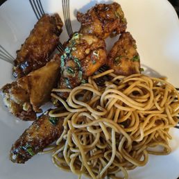 Delicious dirty Elvis wings and garlic noodles, with a stray wing of another flavor. Delicious dirty Elvis wings and garlic noodles, with a stray wing of another flavor.