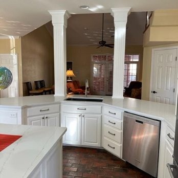 DeWald Remodeling and Plumbing - a kitchen with a brick floor and white cabinets - General Contractors Near Me - Amarillo, Texas DeWald Remodeling and Plumbing - a kitchen with a brick floor and white cabinets - General Contractors Near Me - Amarillo, Texas