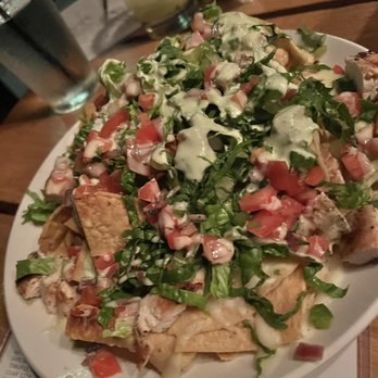 Howell's Kitchen and Bar - Chicken queso blanco nachos  pico de gallo, lettuce, jalapeño crema - 11 add grilled chicken +8, grilled shrimp +9, diced butcher steak +12 - Pizza Near Me - Atlanta, Georgia