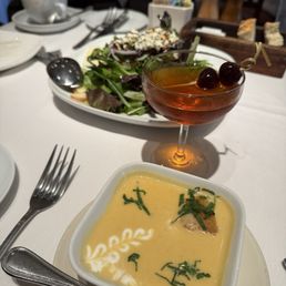 03012025 Arugula salad in the background and Dungeness crab bisque in the forefront 03012025 Arugula salad in the background and Dungeness crab bisque in the forefront
