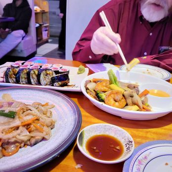 Sake Asian - a man eating a meal with chopsticks - Asian Fusion Near Me - West Babylon, New York Sake Asian - a man eating a meal with chopsticks - Asian Fusion Near Me - West Babylon, New York