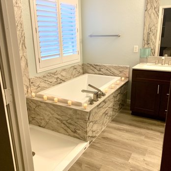 Re-Bath - a bathroom with a tub, sink, and mirror - General Contractors Near Me - Richardson, Texas Re-Bath - a bathroom with a tub, sink, and mirror - General Contractors Near Me - Richardson, Texas