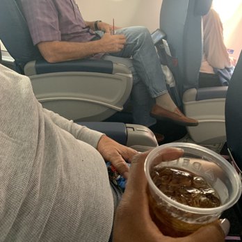 Delta Air Lines - My plastic cup of Jack Black, which is not what I ordered, and the gentleman across the aisle received his drink in a glass - Airlines Near Me - Seattle, Washington Delta Air Lines - My plastic cup of Jack Black, which is not what I ordered, and the gentleman across the aisle received his drink in a glass - Airlines Near Me - Seattle, Washington