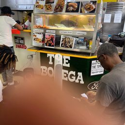 a man ordering food at a food stand a man ordering food at a food stand
