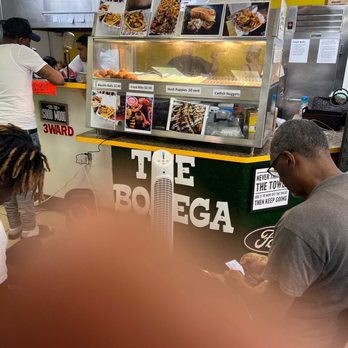 Supreme Gumbo - a man ordering food at a food stand - Chicken Wings Near Me - Houston, Texas Supreme Gumbo - a man ordering food at a food stand - Chicken Wings Near Me - Houston, Texas