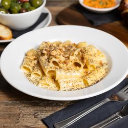 Mali Ston Wine Bar  - Quattro Formaggi Rigatoni  Rigatoni enveloped in a rich four-cheese sauce finished with cracked pepper and walnuts.