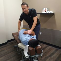 Newport Pain & Wellness - Dr. Nick O'Connor adjusting a patient's lumbar (lower back) region.