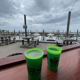 two green cups on a wooden table two green cups on a wooden table