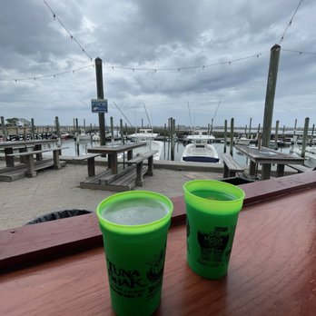 Tuna Shak - two green cups on a wooden table - Tiki Bars Near Me - Murrells Inlet, South Carolina Tuna Shak - two green cups on a wooden table - Tiki Bars Near Me - Murrells Inlet, South Carolina